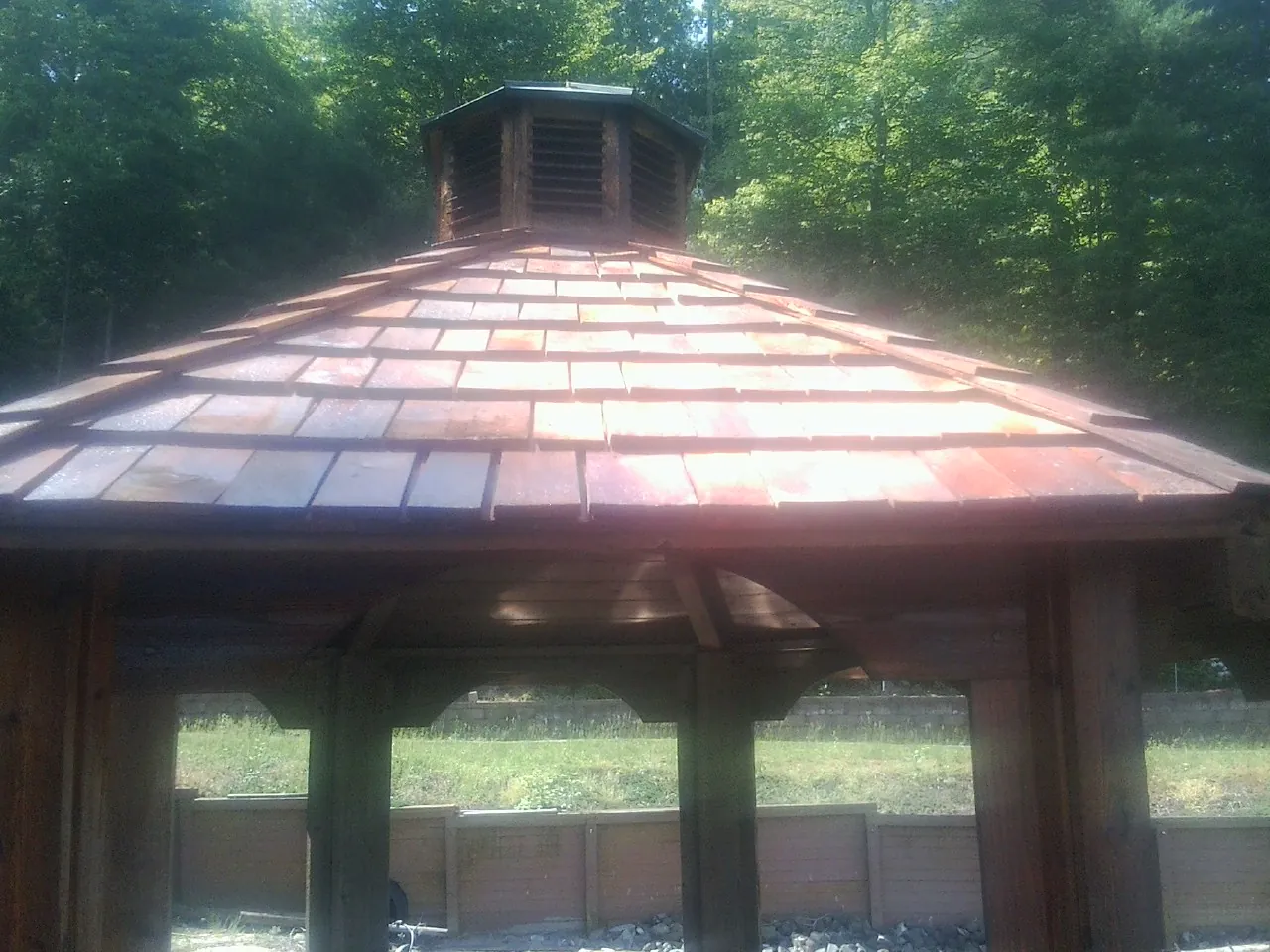 New cedar shake roof and cupola on a lakeside gazebo in Barataria